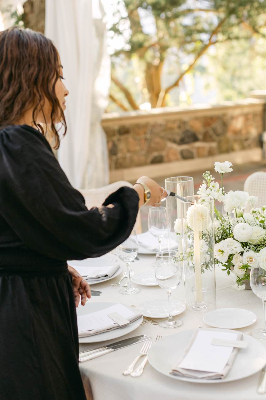 Jaylin Evans lighting a taper candle at a reception table