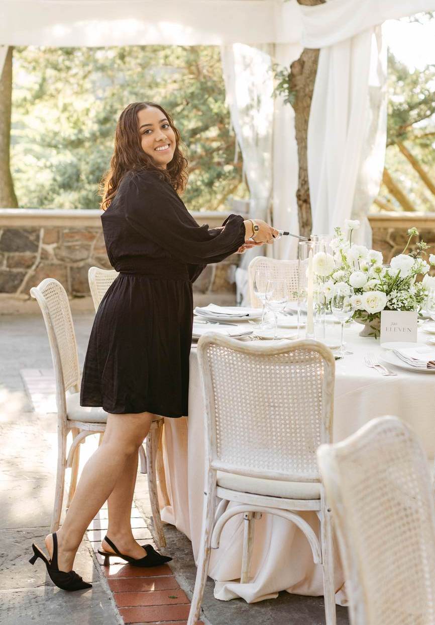 Jaylin Evans, founder of Amourly Events, at a reception table