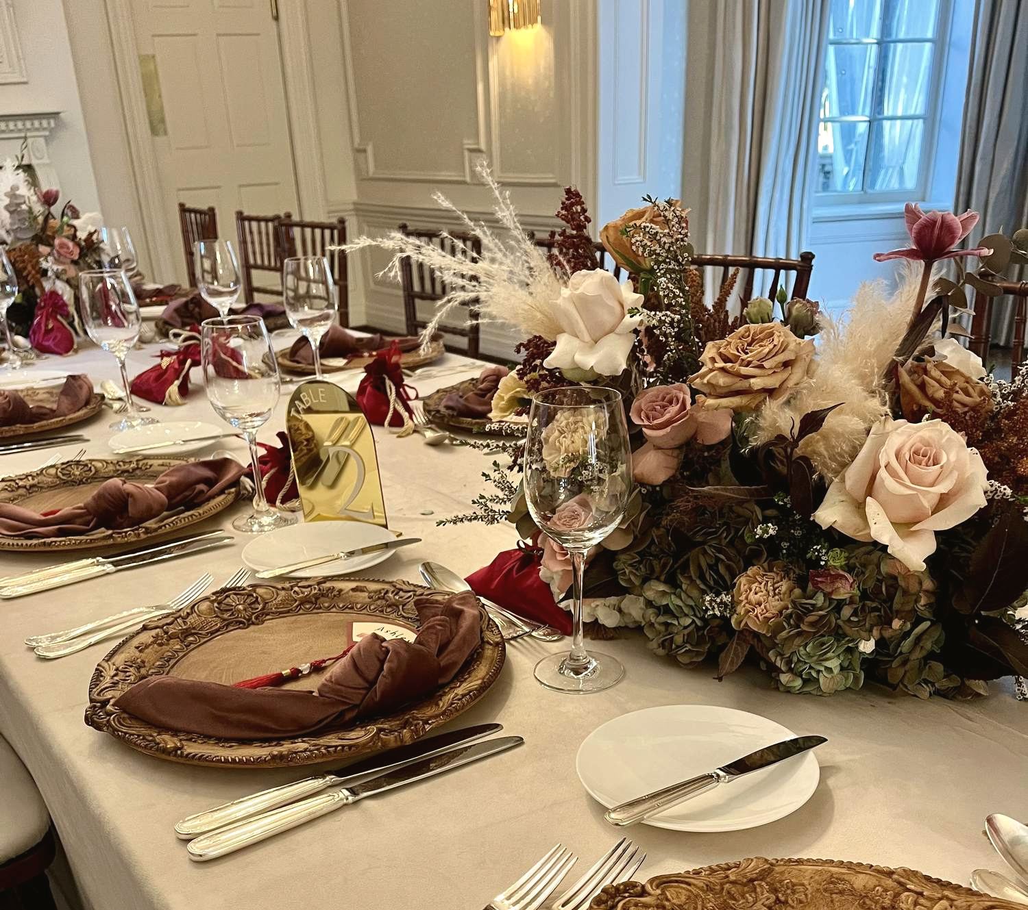 Table setting with vintage gold chargers and dried florals
